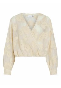 Blouse cache-cœur de couleur crème avec superposition en dentelle florale et manches longues. Présente une bordure festonnée au niveau de l'encolure et un ourlet élastiqué.