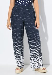 Marineblauwe broek met een wit stippenpatroon, voorzien van een elastische tailleband en een wijde pijpdesign, aangevuld met een gestructureerd oppervlak.
