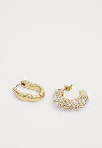 Gold hoop earrings, one smooth design and one embellished with pearls and crystals, featuring a shiny metallic finish and varying shapes.