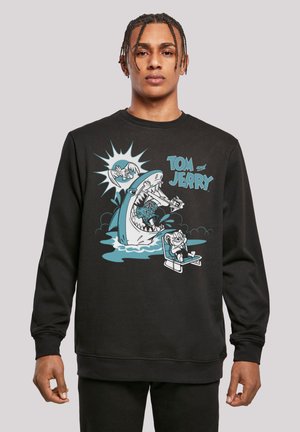 Sort sweatshirts med et tegneserie-design med Tom og Jerry, der viser en haj og en strandstol. Blød tekstur med rund hals.