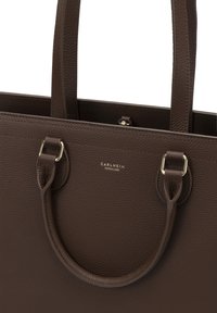 Brown leather tote bag with textured surface, dual top handles, and silver hardware accents. Features the logo “CARLHEIM COPENHAGEN.”