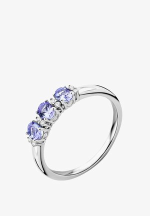 Silver ring featuring three oval tanzanite stones, each flanked by small clear gemstones, with a polished band and smooth curvature.