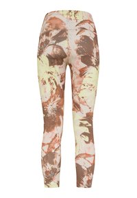 Leggings ajustadas con un diseño floral en tonos marrón, melocotón y amarillo claro. Fabricadas con un tejido elástico de textura suave.