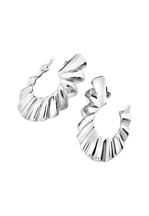 Silver hoop earrings with a ruffled design, featuring ridges and a glossy finish. The earrings are circular with a textured surface.