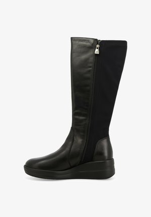 Stivaletti neri al ginocchio in pelle con un esterno in pelle, pannello elastico e cerniera laterale. Il tacco a zeppa offre maggiore altezza e stabilità.
