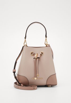 Beige and brown leather bucket bag with gold hardware, drawstring closure, top handle, adjustable shoulder strap, and Michael Kors logo.