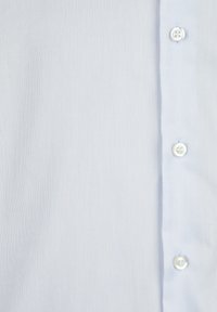 Light blue button-up shirt made of textured fabric featuring a full-length placket with white buttons and a smooth finish.