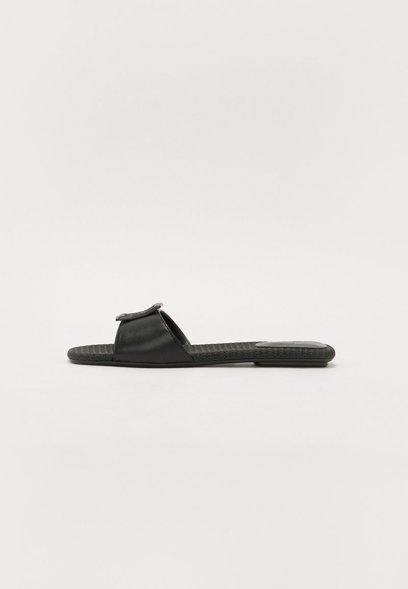 Black slide sandal with two open straps, made of smooth leather, textured footbed, and a flat sole. Simple design without additional accents.