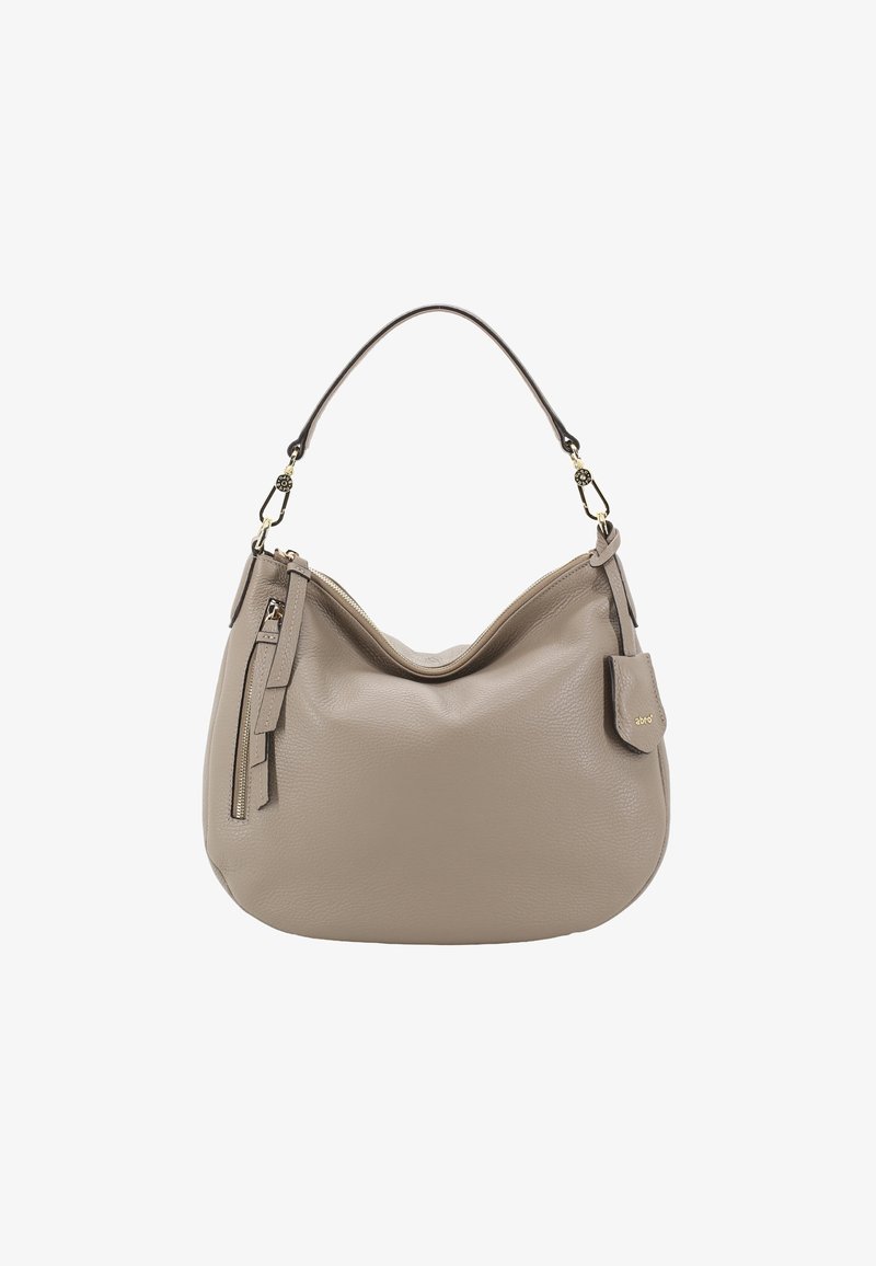 Sac à épaule en cuir beige avec une forme incurvée, une courte poignée, une poche zippée et un pompon décoratif. Accents en métal doré.