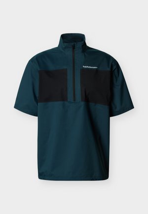 Kortærmet pulloverjakke i mørkegrøn og sort med høj krave, frontlynlås og "Peak Performance"-logo på brystet.