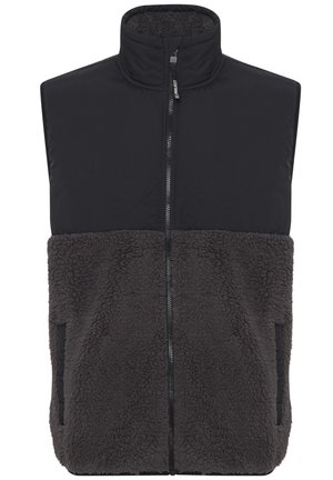 Črn brezrokavnik z zadrgo spredaj, ki ima spodnji del iz flisa v temno sivi barvi. Visok ovratnik, dvoje stranskih žepov in kontrastno teksturo.