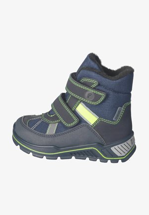 Navy blue children’s boots made of fabric and rubber, featuring double Velcro straps, green accents, and a textured sole for traction.