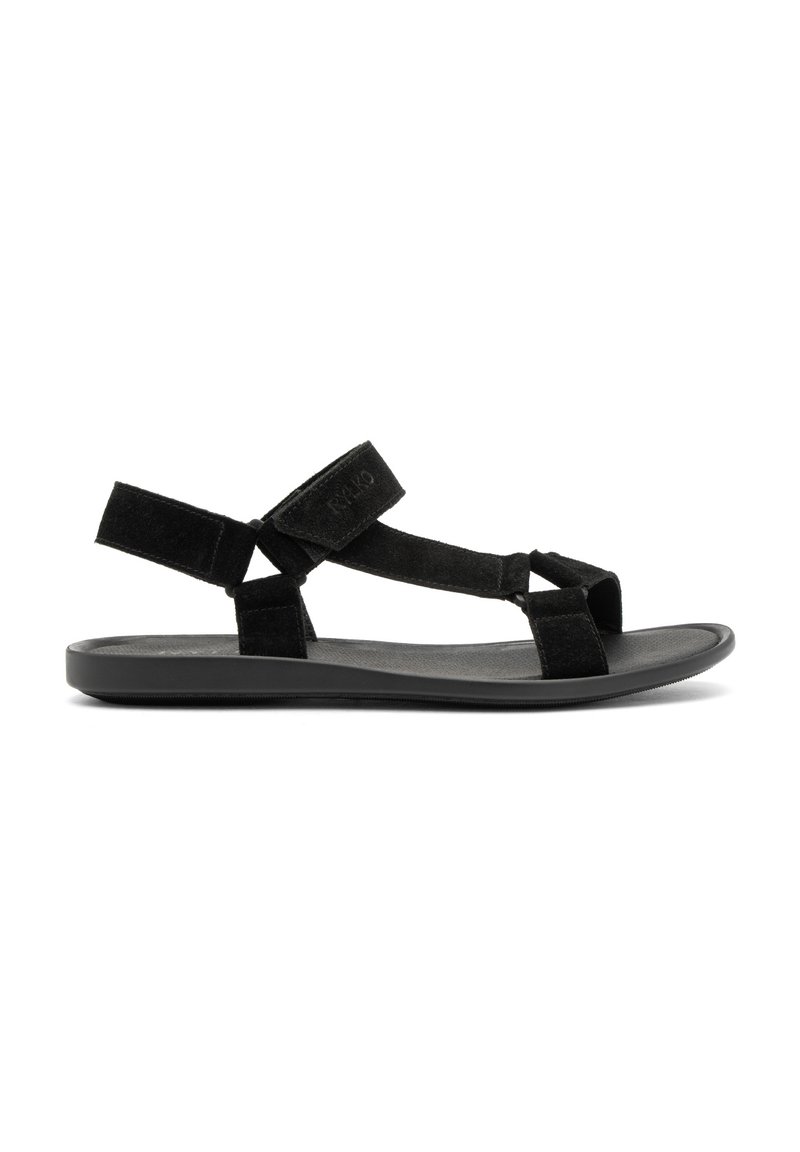 Crne sandale s mekanim nubuk gornjim dijelom, podesivim trakama, elegantnom ravnom potplatom i minimalističkim dizajnom. Pogodne za svakodnevno nošenje.