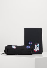 Sort notesbog med NASA-patches og et matchende sort penalhus med astronaut- og NASA-logo designs, begge med en glat overflade.