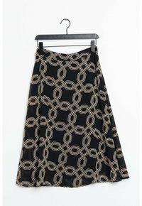 Jupe noire en A avec un motif de chaîne beige, suspendue à un cintre en plastique noir sur fond blanc.