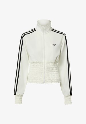 Biała bluza dresowa Adidas zapinana na zamek, z czarnymi pasami na rękawach, marszczoną talią i mankietami oraz logo Trefoil Adidas na piersi.