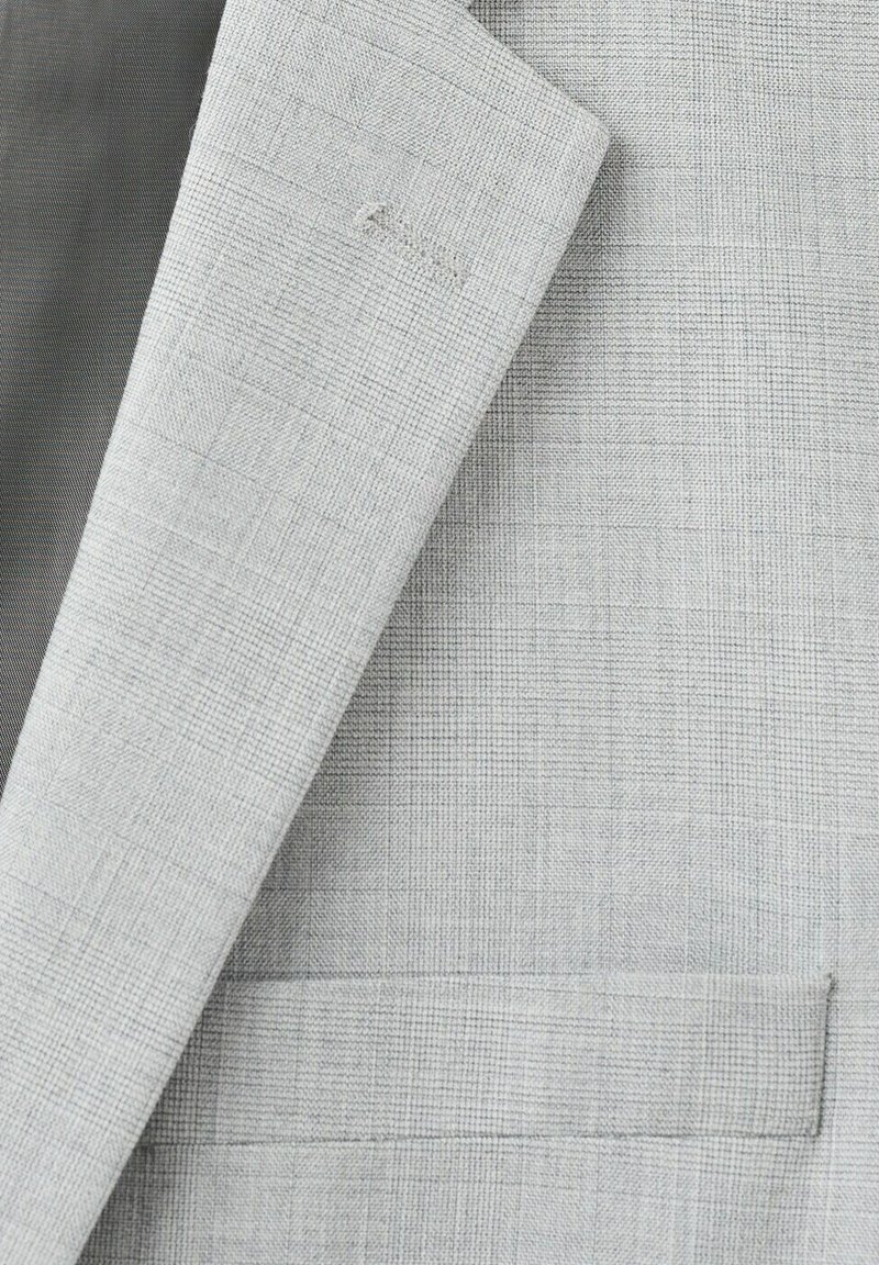 Lichtgrijs colbert met subtiel geruit patroon, met zichtbare rever en paspelzakdetails.