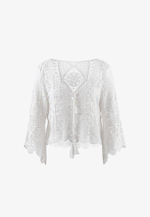 Hvid hæklede blondebluse med klokkeærmer, V-hals, blomsterprint, bølget kant og forreste frynset ties.