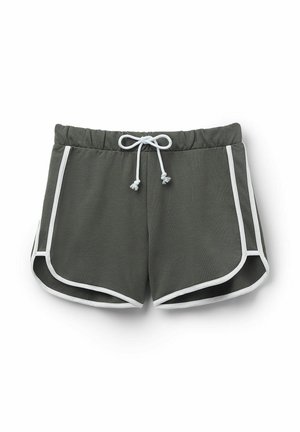 Zelené sportovní šortky s pružným pasem na šňůrku, bílé akcenty podél stran a klasický střih. Vyrobeny z měkké, lehké tkaniny.