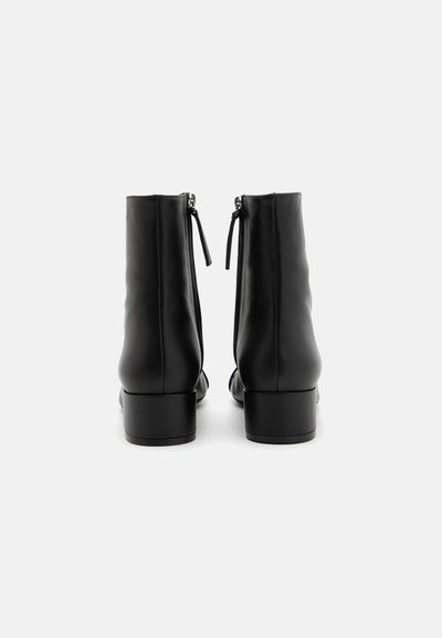 Black leather ankle boots with a smooth finish, featuring a rounded toe, block heel, and rear zipper with small fabric pull tab.