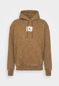 Felpa marrone con finitura testurizzata, cappuccio con cordino, tasca frontale e una patch con logo che presenta una silhouette e una firma in bianco.