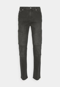 Jeans de mezclilla negra con acentos acanalados en las rodillas, diseño ajustado, cinco bolsillos y cierre clásico de botón y cremallera.