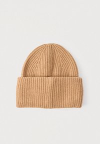 Helepruun kootud müts soonilise tekstuuri ja volditud äärega. Ümar tipp vertikaalsete joontega üle kogu pinna.