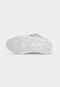 White sneaker sole with textured pattern featuring circular bumps and abstract shapes, shown against a plain white background.