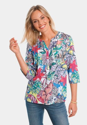 Bluse aus Baumwollmischung mit Floraldesign, mit Dreiviertelärmeln, V-Ausschnitt mit Knöpfen und lebhaften Farben wie Pink, Blau und Grün.