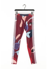 Flerfärgade leggings med en vinröd bas och abstrakta former i blått, rosa och lila. Vita sidremsor och en Adidas-logotyp.
