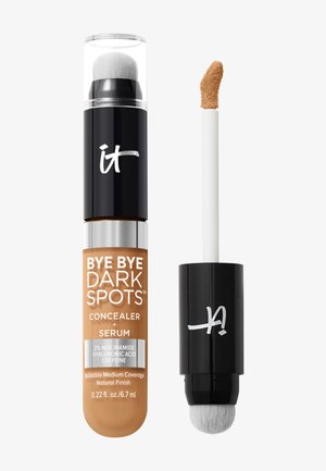 Correcteur et sérum à double embout avec un applicateur-éponge à une extrémité et un applicateur mousse incliné à l'autre, teinte beige moyen.