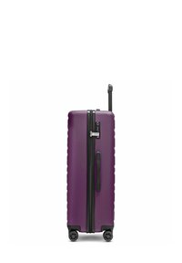 Valigia rigida di colore viola con texture a coste verticali, zipper nero e maniglia, e quattro ruote per la mobilità. Inclusa maniglia retraibile.