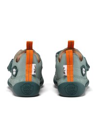 Scarpe per bambini in pelle verde con linguette arancioni, dettagli testurizzati e suole in gomma. Presentano il marchio sui talloni e sui lati.