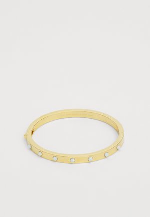 Kultaiset rannekorut, joissa on sileä pinta, kuusi vaaleansinistä opaalimaisuutta korostavaa yksityiskohtaa ja turvallinen solki. Minimalistinen ja pyöreä muoto.