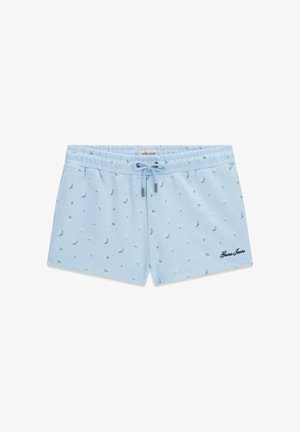 Light blue women's shorts with small white floral print, elastic waistband, drawstring, and "Guess Jeans" logo on the front.