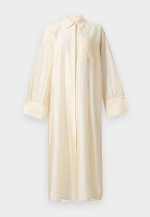 Satinlangarmhemd in hellem Beige mit Kragen, durchgehender Knopfleiste und einer Brusttasche. Lange Ärmel mit geknöpften Manschetten.