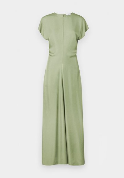 Πράσινη, λεία φόρμα χωρίς μανίκια με καπάκια, ψηλό λαιμό και φερμουάρ στην πλάτη. Διαθέτει χαλαρή εφαρμογή και φαρδιά πόδια.