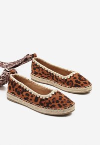 Espadrilles à imprimé léopard avec un dessus en suède marron, un bord festonné crème et une semelle en corde de jute. Dotées d'une sangle en tissu à imprimé léopard réglable.