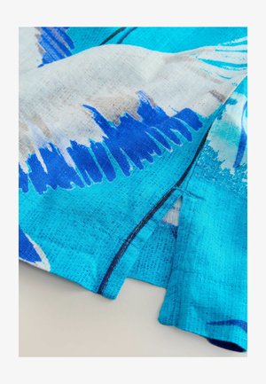 Blue and turquoise patterned fabric with abstract brushstrokes, featuring a smooth texture and visible stitching along the edges.