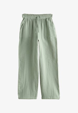 Light green loose-fit pants with an elastic waistband and drawstring, featuring front patch pockets and a textured fabric.