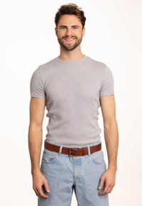 Graues, geripptes, kurzärmliges T-Shirt aus Baumwolle, kombiniert mit hellblauen Jeans und einem braunen Ledergürtel mit rechteckiger Schnalle.
