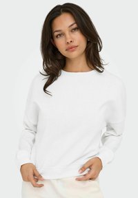 Sweatshirt bianco con scollatura tonda e maniche lunghe, caratterizzato da polsini e orlo a costine. Texture liscia, vestibilità comoda, design minimalista.