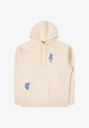 Beige hættetrøje med frontlomme, snoretræk, blåt abstrakt ansigtsdesign nær brystet med rød tekst og lille blåt grafik på højre side af lommen.