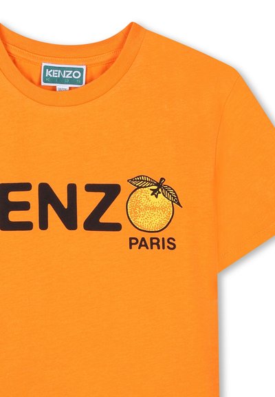 T-shirt en coton orange vif avec un logo noir "KENZO" et un graphique orange représentant des feuilles, placé au-dessus du mot "PARIS".