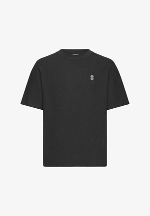 Schwarzes T-Shirt mit kurzen Ärmeln aus strukturiertem Stoff, mit Rundhalsausschnitt und einem dezenten, gestickten Logo auf der Brust.