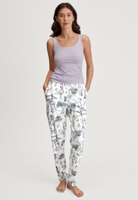 Light purple tank top with a scoop neckline paired with white pajama pants featuring a black sketch pattern of landmarks and playful elements.