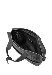 Black leather bag with a zip closure, featuring a spacious interior lined in fabric, and sturdy handles. Includes an interior pocket.