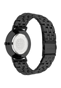 Schwarze Edelstahl-Uhr mit geflochtenem Armband, rundem Gehäuse und einem markierten, reflektierenden Rücken. Wasserdicht bis 3 ATM.