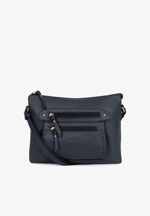 Sac bandoulière en cuir bleu marine avec sangle réglable, deux poches avant zippées et tirettes de fermeture éclair ainsi que clous couleur or.