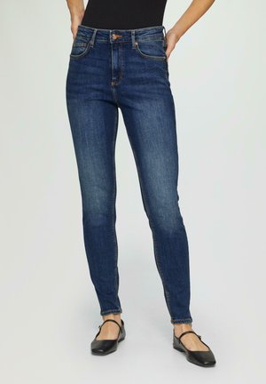 Schmale Bla Jeans aus Denim, mit fünf Taschen, einem äußeren Knopfverschluss und sichtbaren Nähten entlang der Nähte.